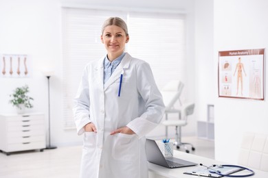 Photo of Portrait of professional doctor wearing white coat in hospital