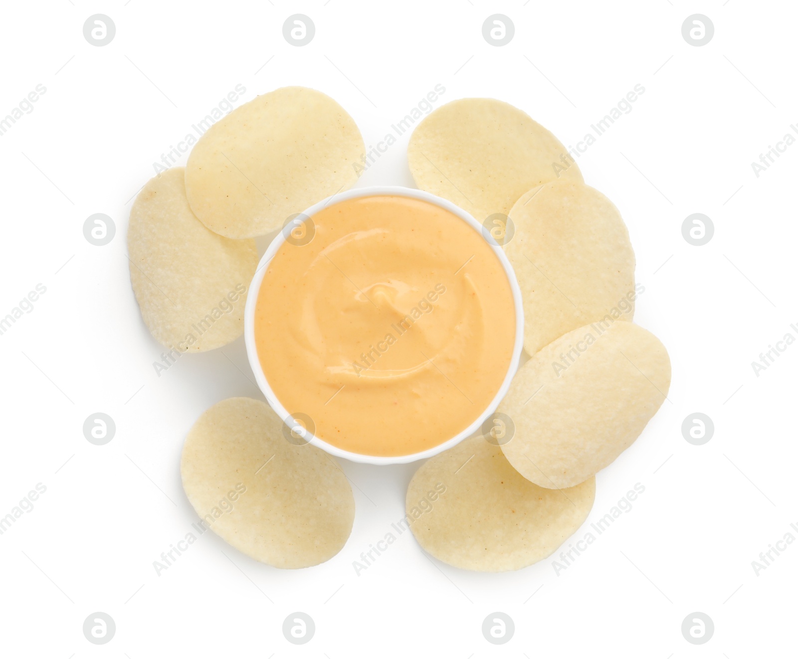 Tasty cheese dipping sauce in bowl and potato chips isolated on white, top view Photo of Tasty cheese dipping sauce in bowl and potato chips isolated on white, top view