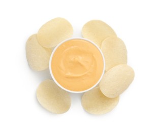 Photo of Tasty cheese dipping sauce in bowl and potato chips isolated on white, top view