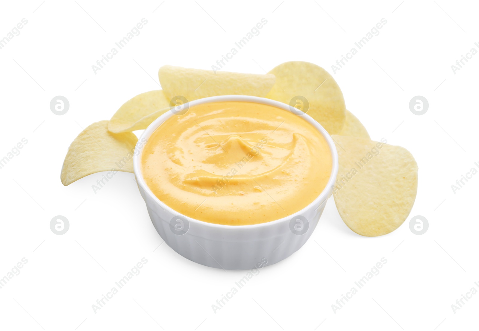 Tasty cheese dipping sauce in bowl and potato chips isolated on white Photo of Tasty cheese dipping sauce in bowl and potato chips isolated on white