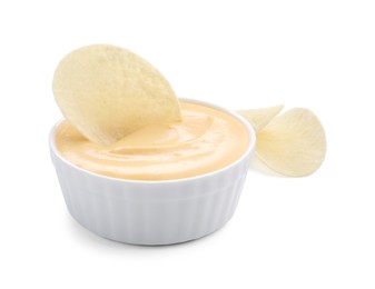 Photo of Tasty cheese dipping sauce in bowl and potato chips isolated on white