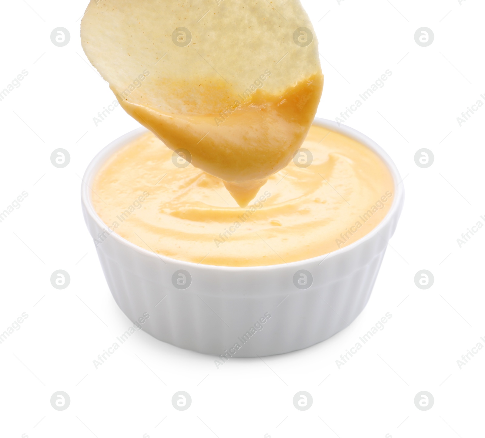 Dipping potato chip into tasty cheese sauce on white background, closeup Photo of Dipping potato chip into tasty cheese sauce on white background, closeup