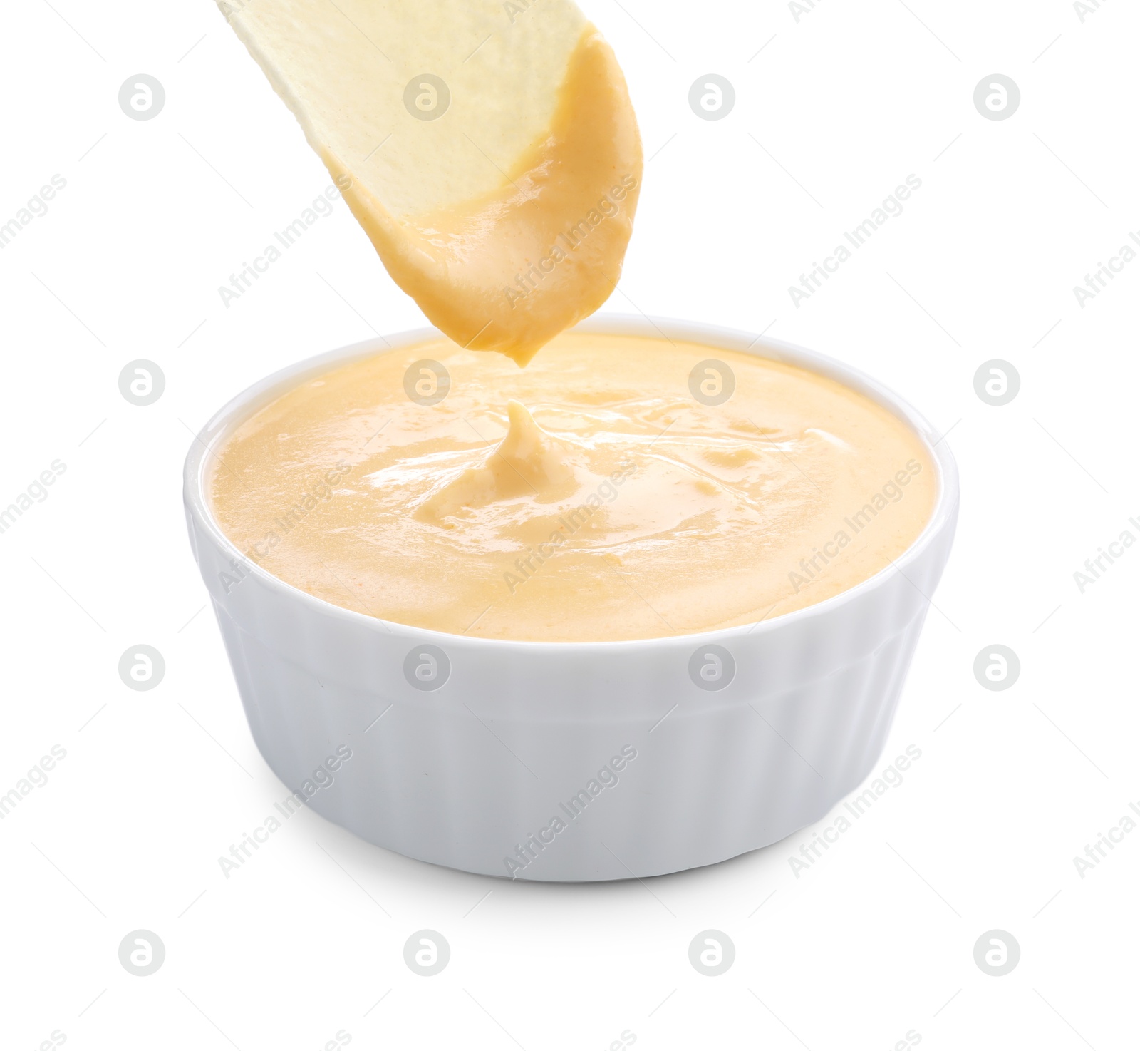 Dipping potato chip into tasty cheese sauce on white background, closeup Photo of Dipping potato chip into tasty cheese sauce on white background, closeup