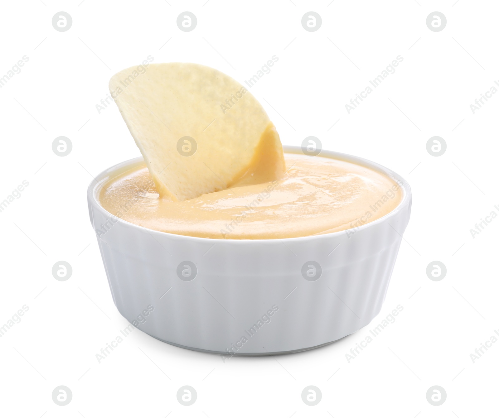 Photo of Tasty cheese dipping sauce in bowl and potato chip isolated on white