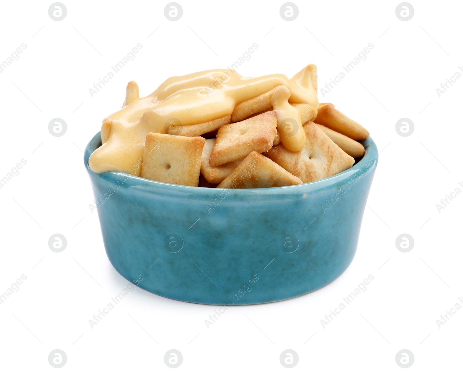 Photo of Crackers with tasty cheese sauce in bowl isolated on white