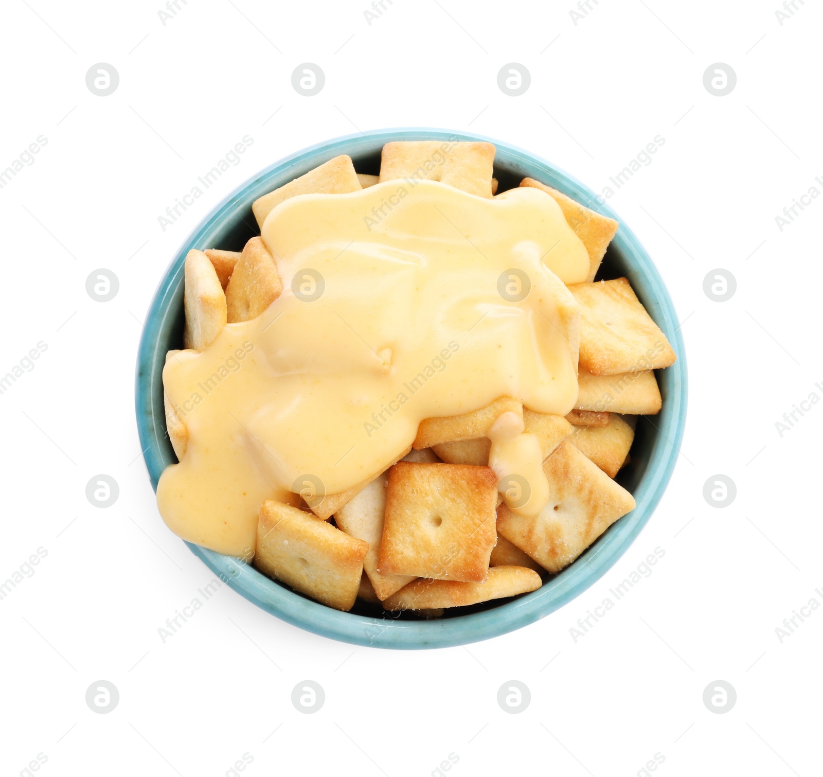 Photo of Crackers with tasty cheese sauce in bowl isolated on white, top view