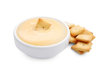 Photo of Tasty cheese dipping sauce in bowl and crackers isolated on white