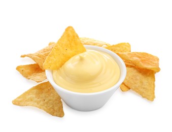 Photo of Tasty cheese dipping sauce in bowl and nacho chips isolated on white