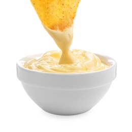 Photo of Dipping nacho chip into tasty cheese sauce on white background, closeup