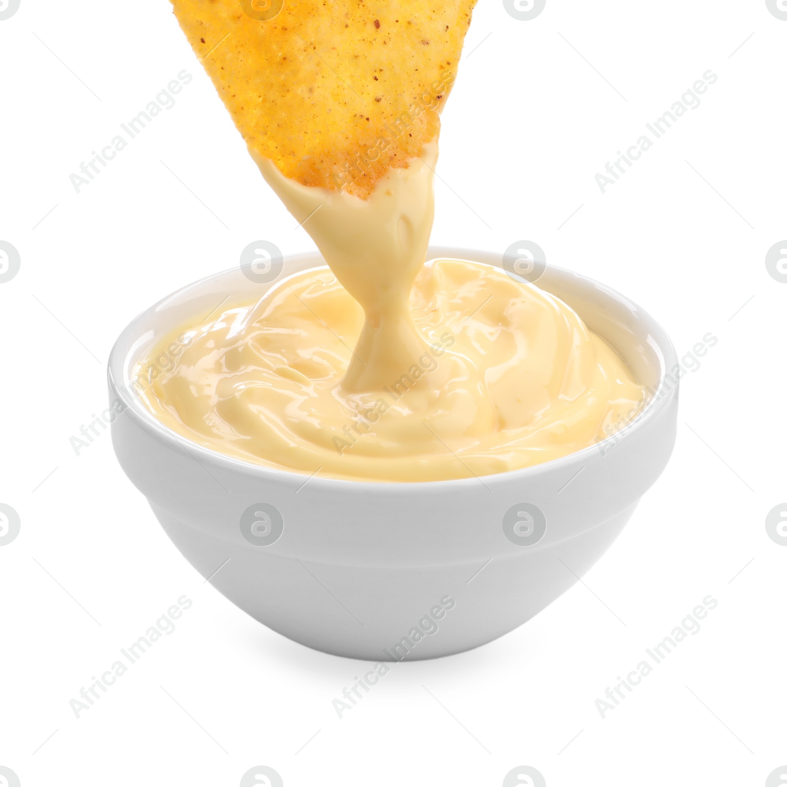 Dipping nacho chip into tasty cheese sauce on white background, closeup Photo of Dipping nacho chip into tasty cheese sauce on white background, closeup