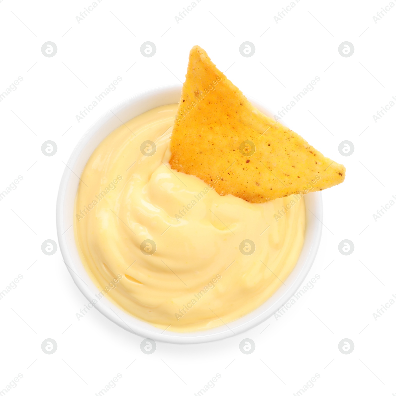 Tasty cheese dipping sauce in bowl and nacho chip isolated on white, top view Photo of Tasty cheese dipping sauce in bowl and nacho chip isolated on white, top view