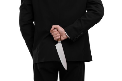 Photo of Businessman holding knife behind his back on white background, closeup