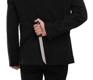 Photo of Businessman holding knife behind his back on white background, closeup