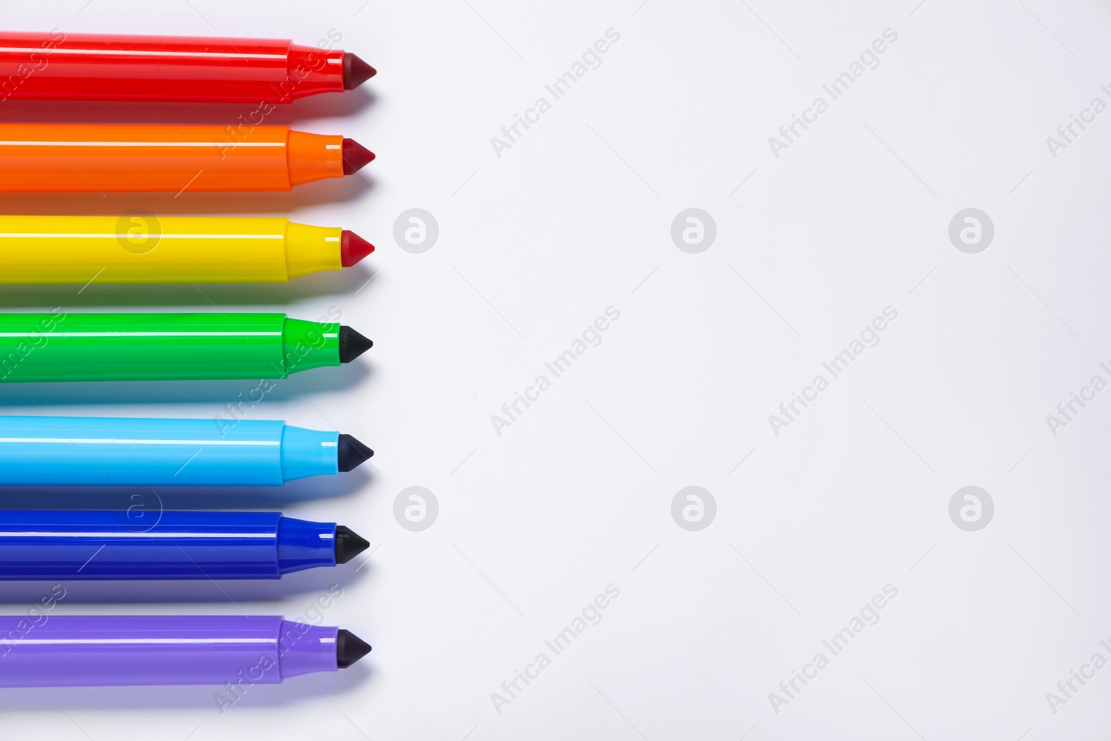 Photo of Many colorful markers on white background, flat lay. Space for text