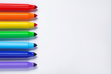 Photo of Many colorful markers on white background, flat lay. Space for text