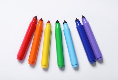 Photo of Many colorful markers on white background, flat lay