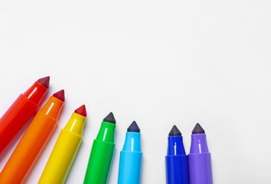 Photo of Many colorful markers on white background, flat lay. Space for text