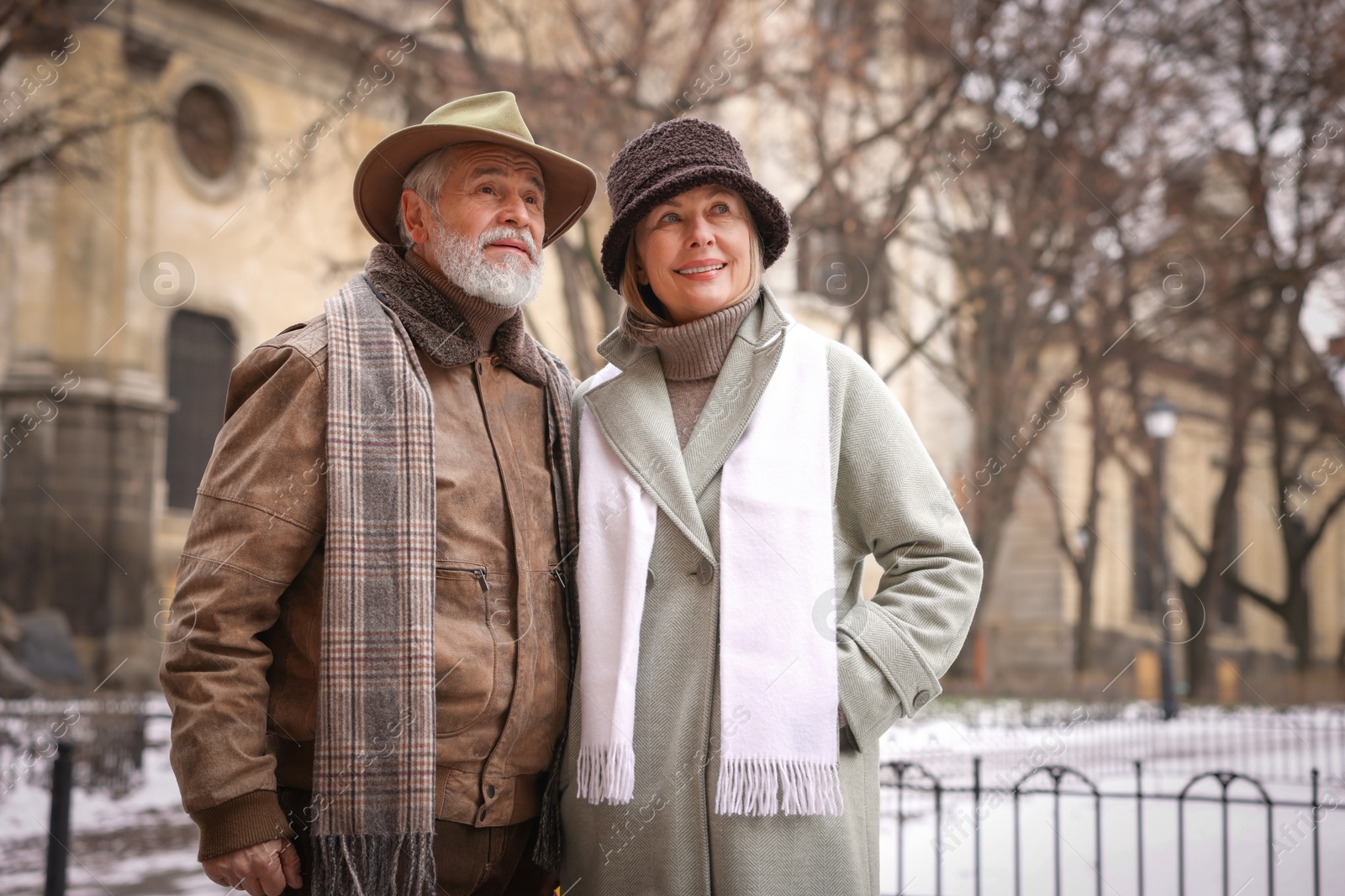 Photo of Portrait of senior couple on city street. Space for text