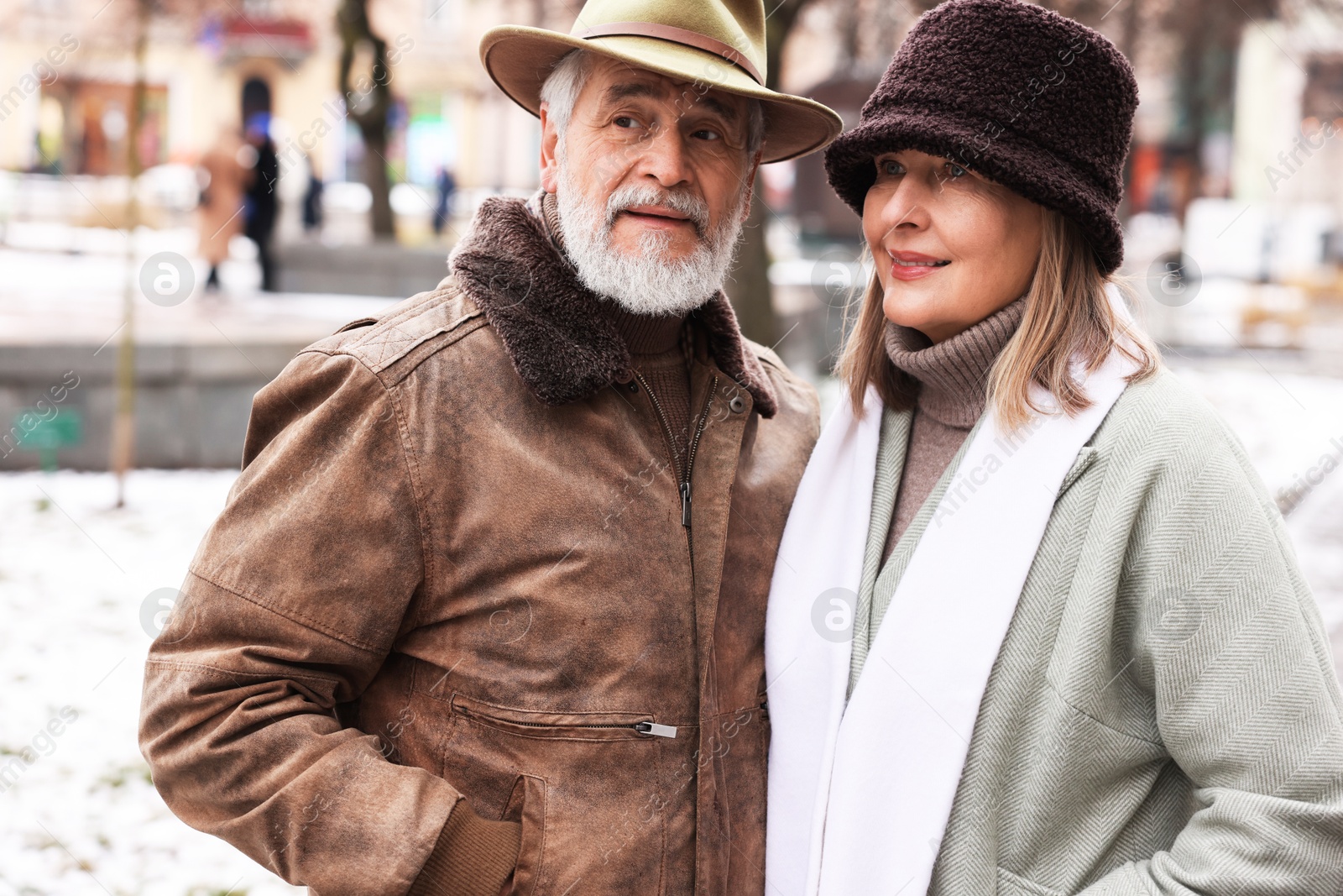 Photo of Lovely senior couple walking on city street