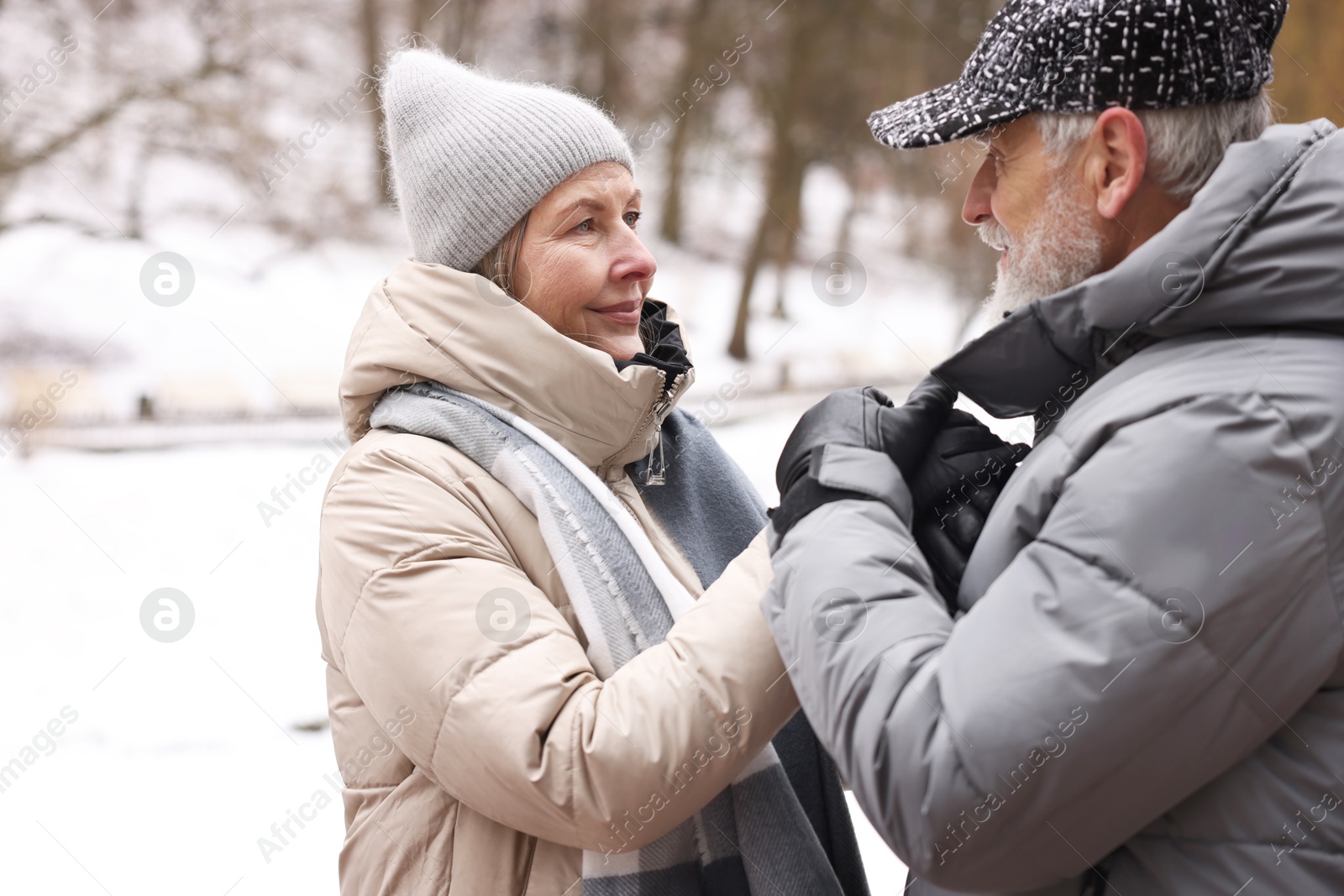 Photo of Lovely senior couple holding hands at winter park