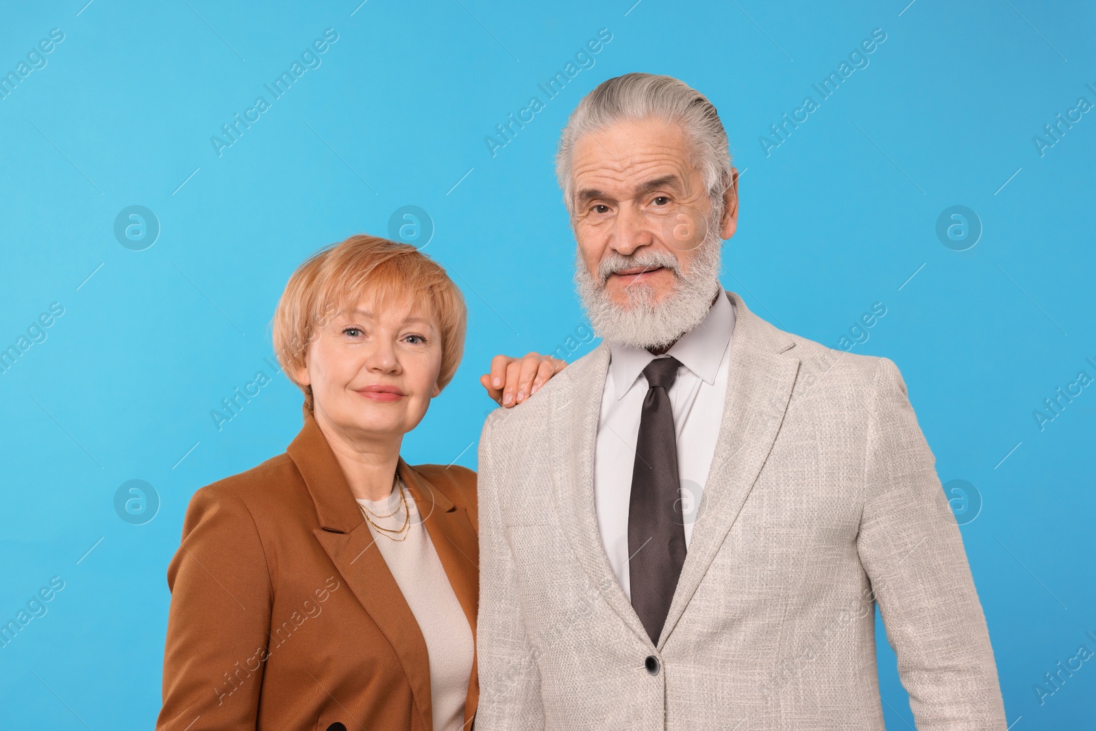 Photo of Portrait of lovely senior couple on light blue background