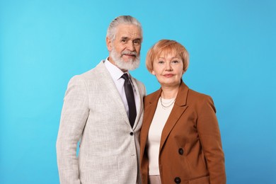 Photo of Portrait of lovely senior couple on light blue background