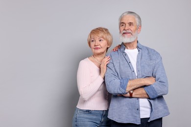 Photo of Lovely senior couple on grey background. Space for text