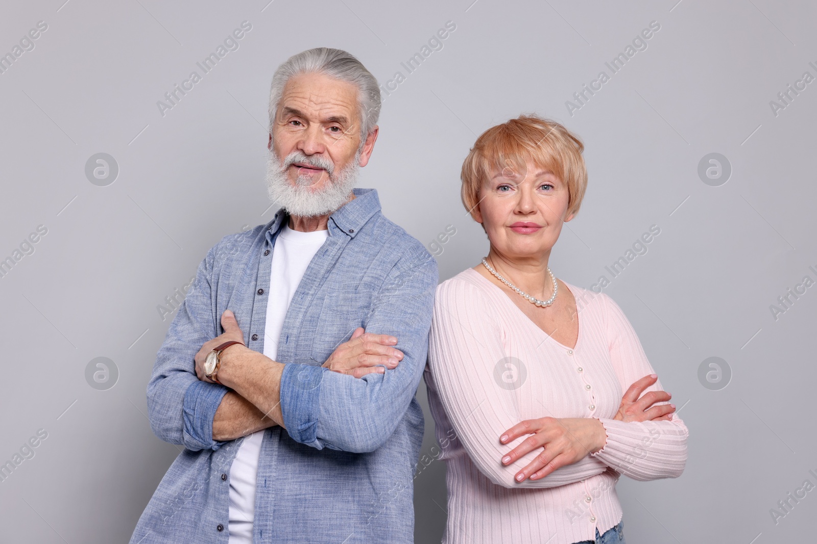 Photo of Portrait of lovely senior couple on grey background