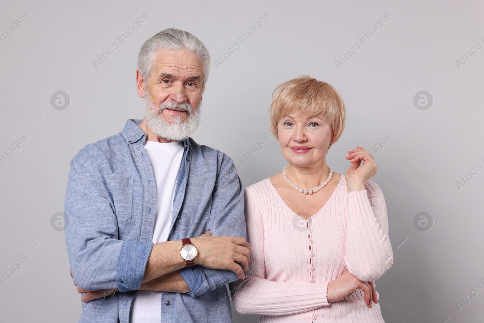 Photo of Portrait of lovely senior couple on grey background