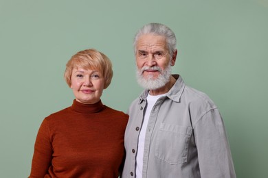 Photo of Portrait of lovely senior couple on green background