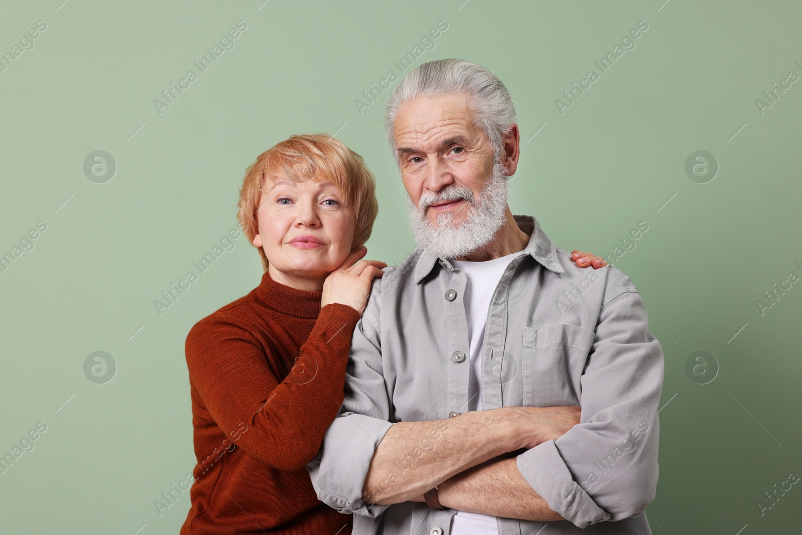 Photo of Portrait of lovely senior couple on green background