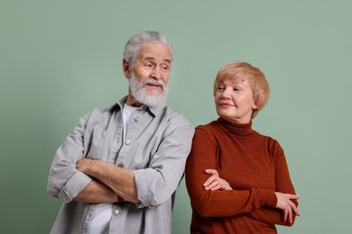 Photo of Lovely senior couple with crossed arms on green background