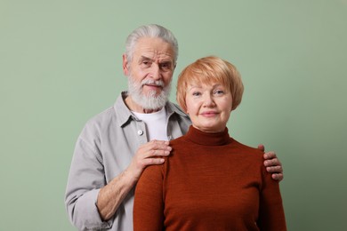 Photo of Portrait of lovely senior couple on green background