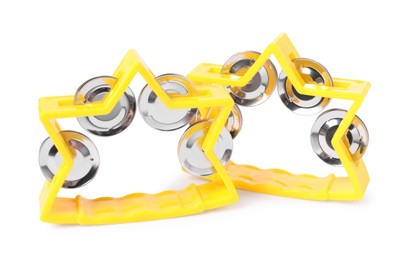 Photo of Yellow toy tambourines isolated on white. Child's musical instrument