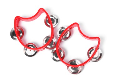 Red toy tambourines isolated on white, top view. Child's musical instrument