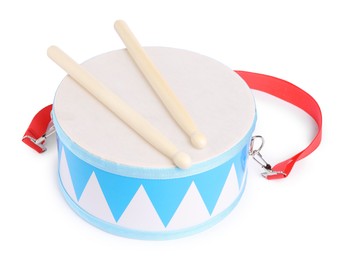 Photo of Toy drum with drumsticks isolated on white. Child's musical instrument