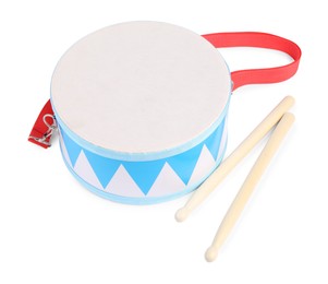 Toy drum with drumsticks isolated on white. Child's musical instrument