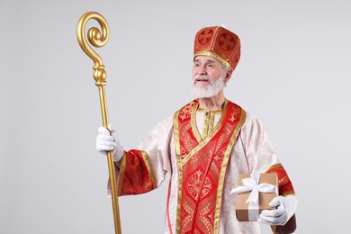 Saint Nicholas with gift on light grey background