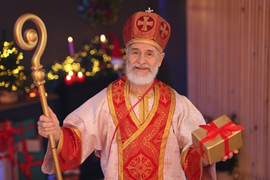 Photo of Saint Nicholas in room decorated for Christmas