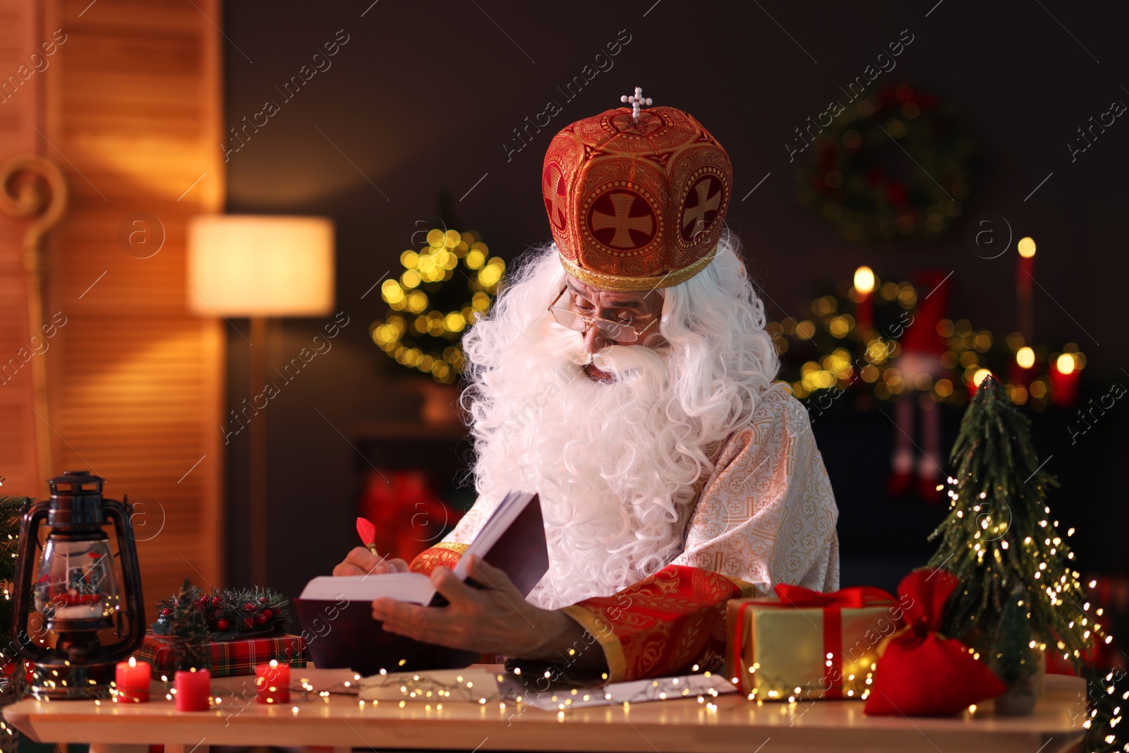 Photo of Saint Nicholas in room decorated for Christmas