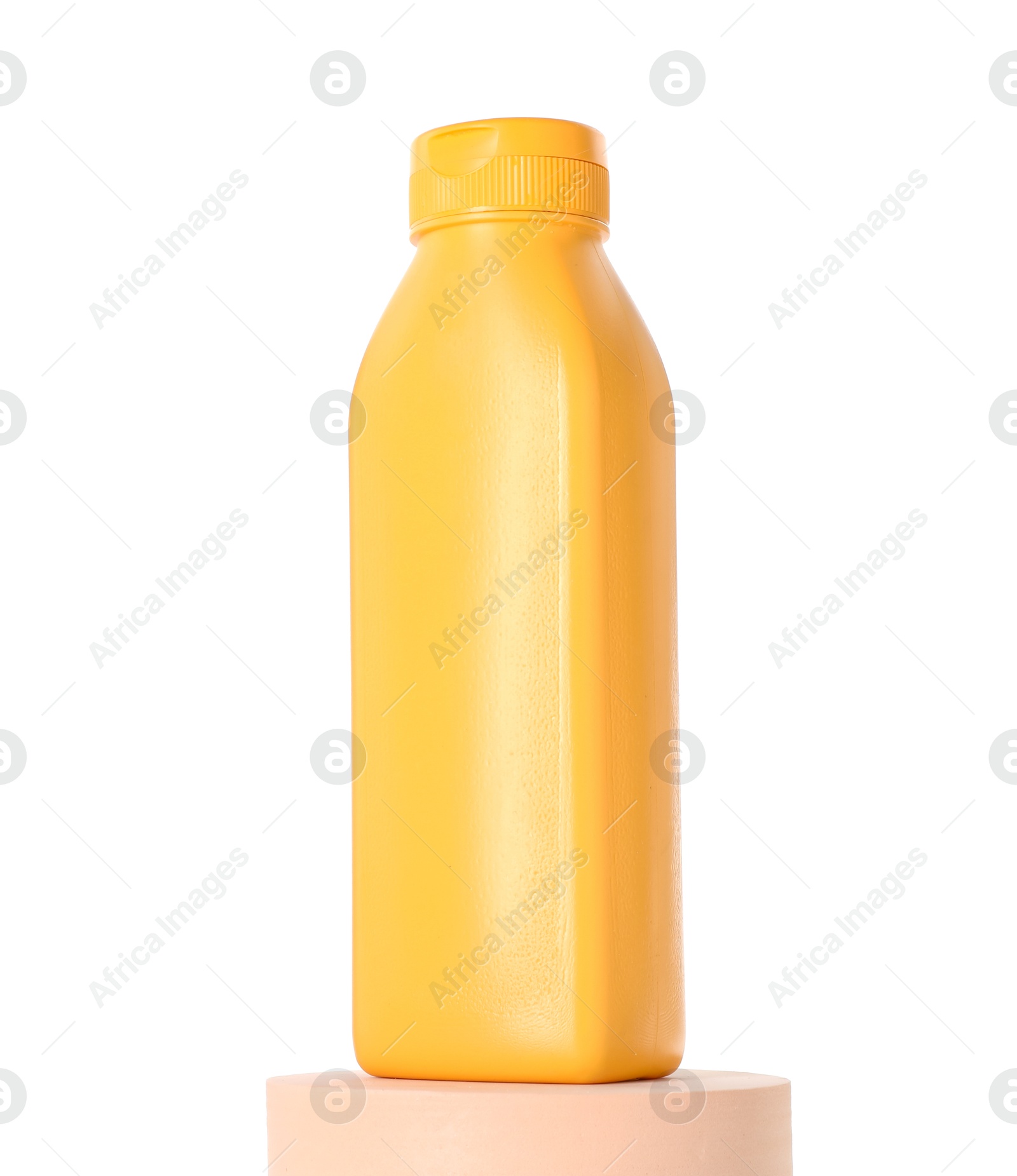 Photo of Bottle of sun protection product on podium against white background