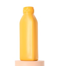 Photo of Bottle of sun protection product on podium against white background