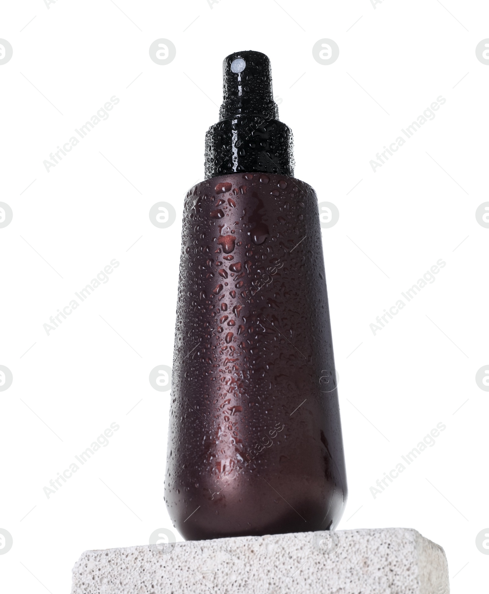 Photo of Bottle of sun protection product on concrete block against white background