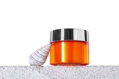 Photo of Jar of sun protection product and seashell on concrete surface against white background