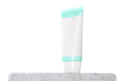 Photo of Tube of sun protection product on concrete block against white background