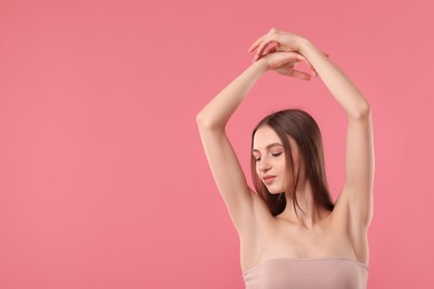 Photo of Young woman showing smooth skin after epilation on pink background, space for text