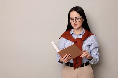 Photo of English teacher with book on light grey background. Space for text