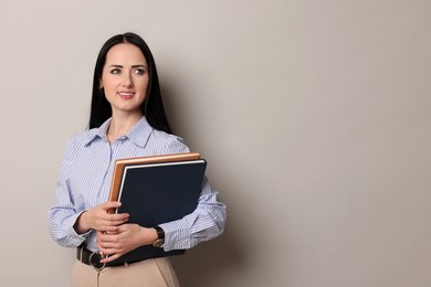 Photo of English teacher with books on light grey background. Space for text