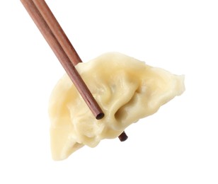 Photo of Chopsticks with tasty boiled gyoza (dumpling) on white background