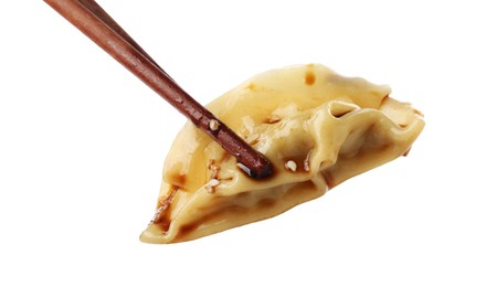 Photo of Chopsticks with tasty boiled gyoza (dumpling) on white background